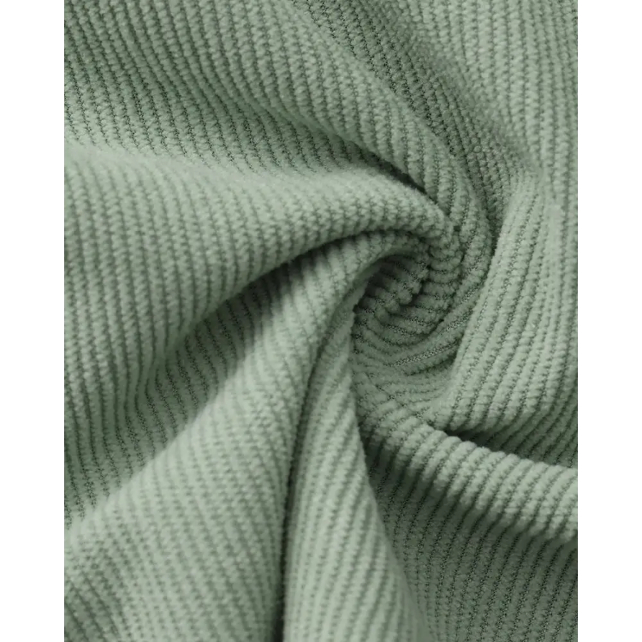 Fine-ribbed corduroy fabric close-up showing breathable weave texture