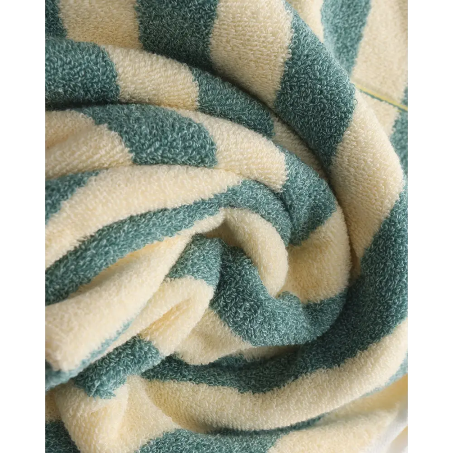 Navy and green striped towels hanging on towel rack, showing both colors