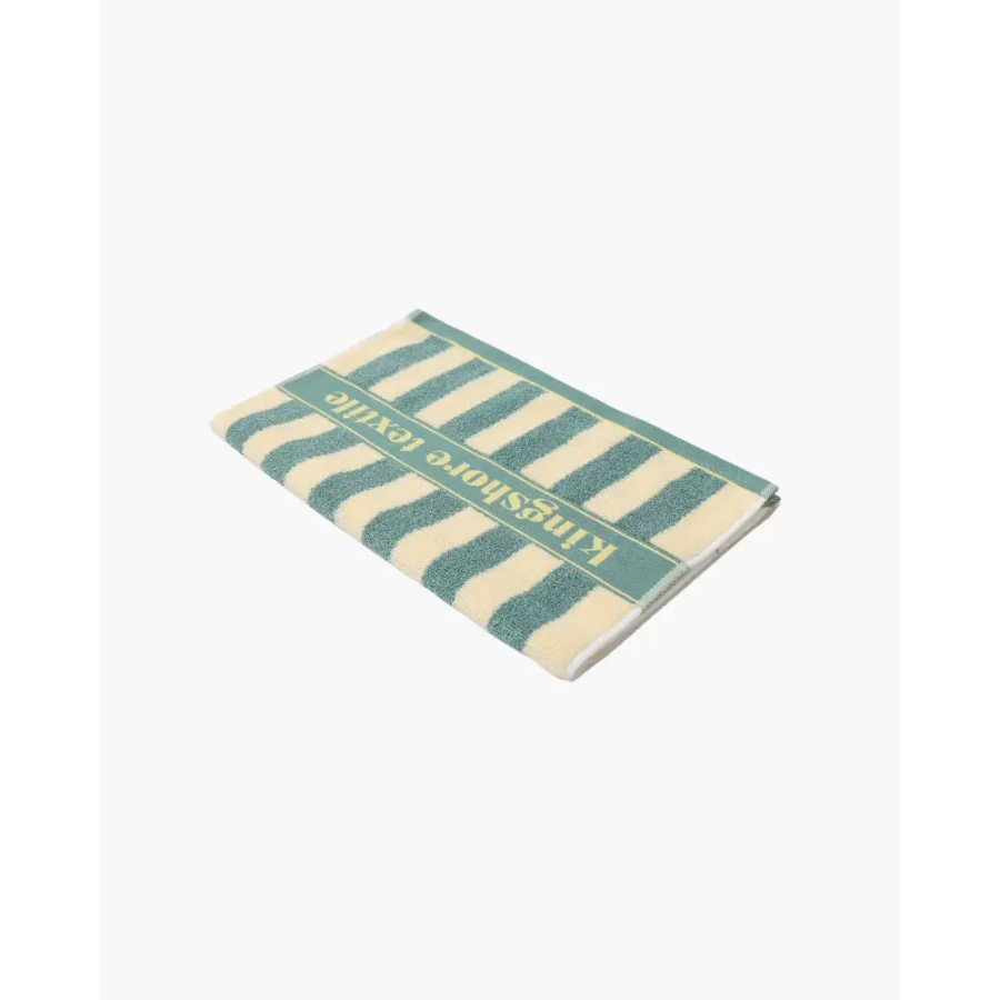 Navy striped hand towel draped on towel bar, demonstrating quick-dry capability