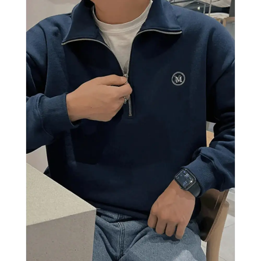 Half-zip pullover sweatshirt layered under tailored blazer