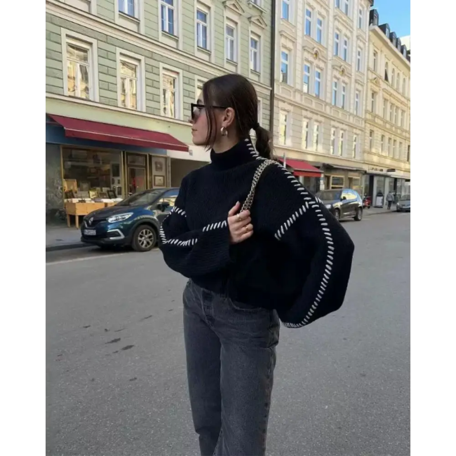 Contrast stitch sweater worn layered under navy blazer