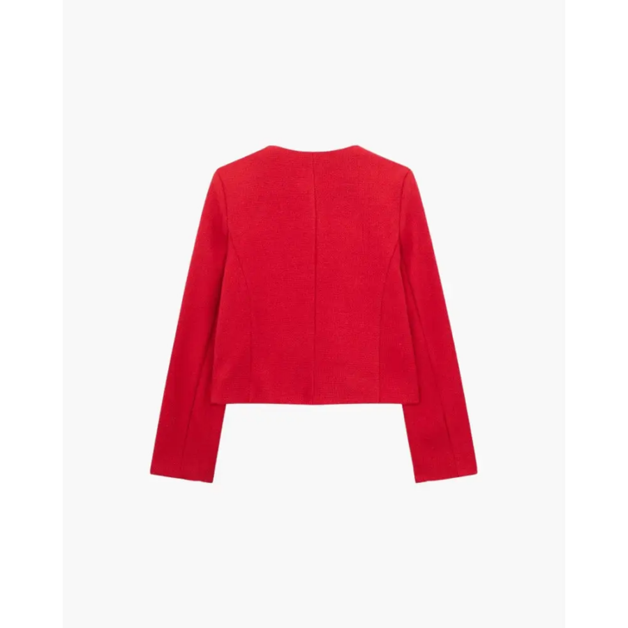 Cropped tailored blazer worn over white shirt and trousers, office styling