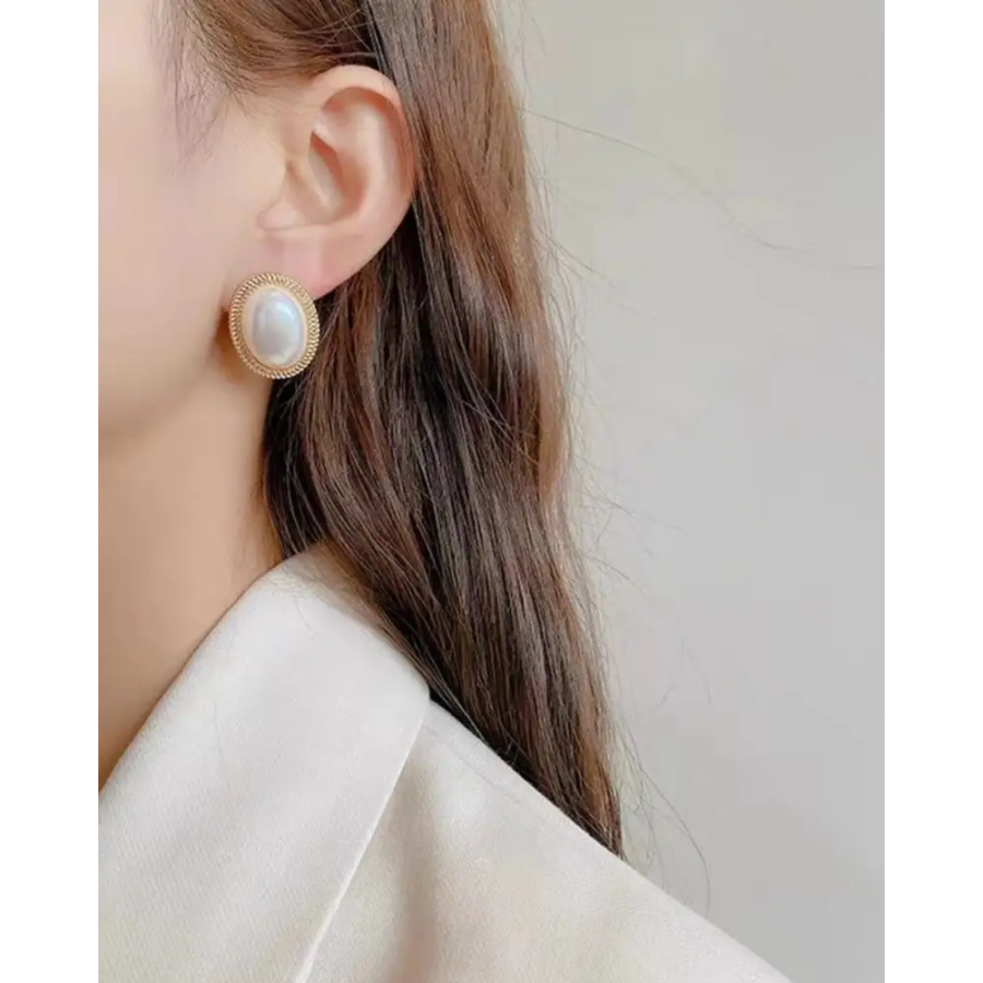 Close-up of gold oval pearl stud showing real gold plating and imitation pearl luster