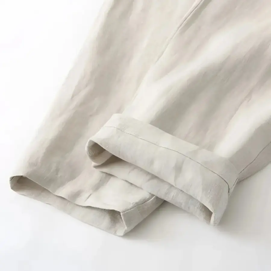 Close-up detail of linen drawstring trousers waistband and adjustable drawstring