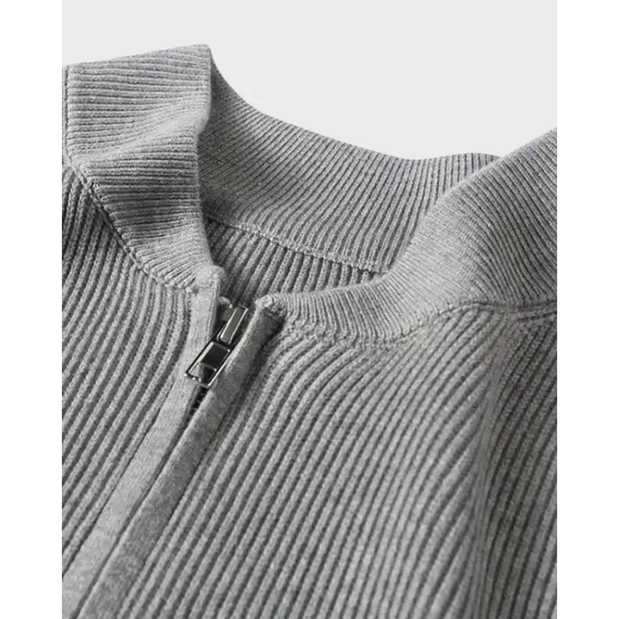 Minimalist zip cardigan flat lay detail of zipper pull and textured knit weave