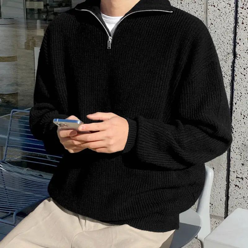 Cotton quarter-zip sweater detail showing ribbed cuff texture and quarter-zip collar closure, side view