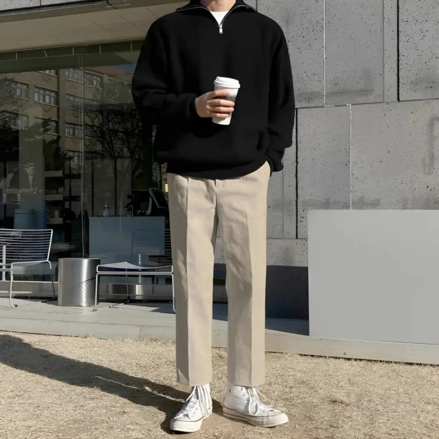 Relaxed fit cotton sweater draped across shoulders, demonstrating drape and tailored silhouette from above
