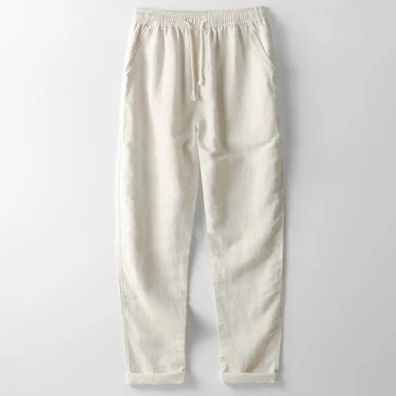 Close-up of navy linen shirt fabric texture and button front, cream trousers waistband detail