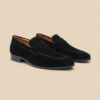 Old Money calf suede loafers in black, three-quarter view showing slip-on silhouette