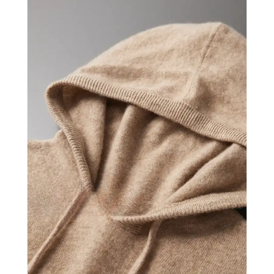 Cashmere hoodie layered over white shirt, refined silhouette