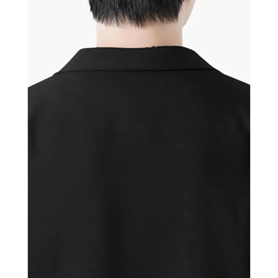 Matched black blazer and straight-leg trousers, quiet luxury styling