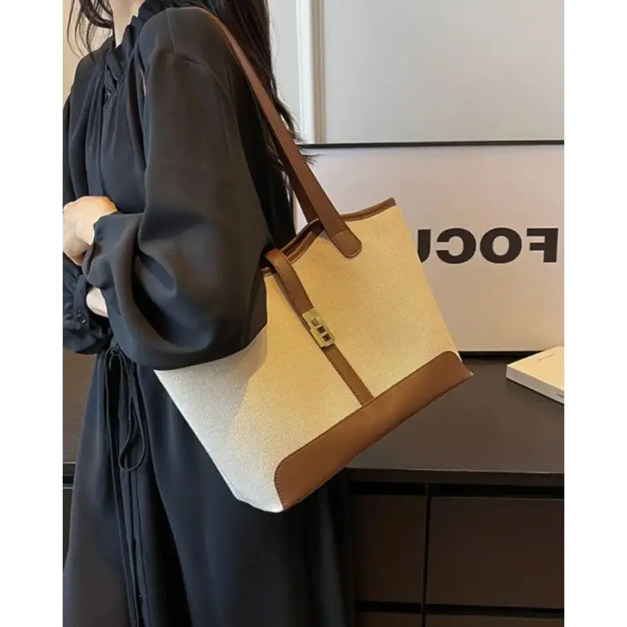 Canvas shoulder bag detail of leather strap and brass D-ring hardware