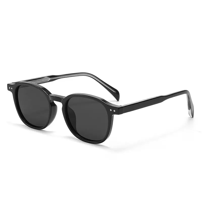 Black retro round sunglasses, three-quarter view highlighting acetate construction