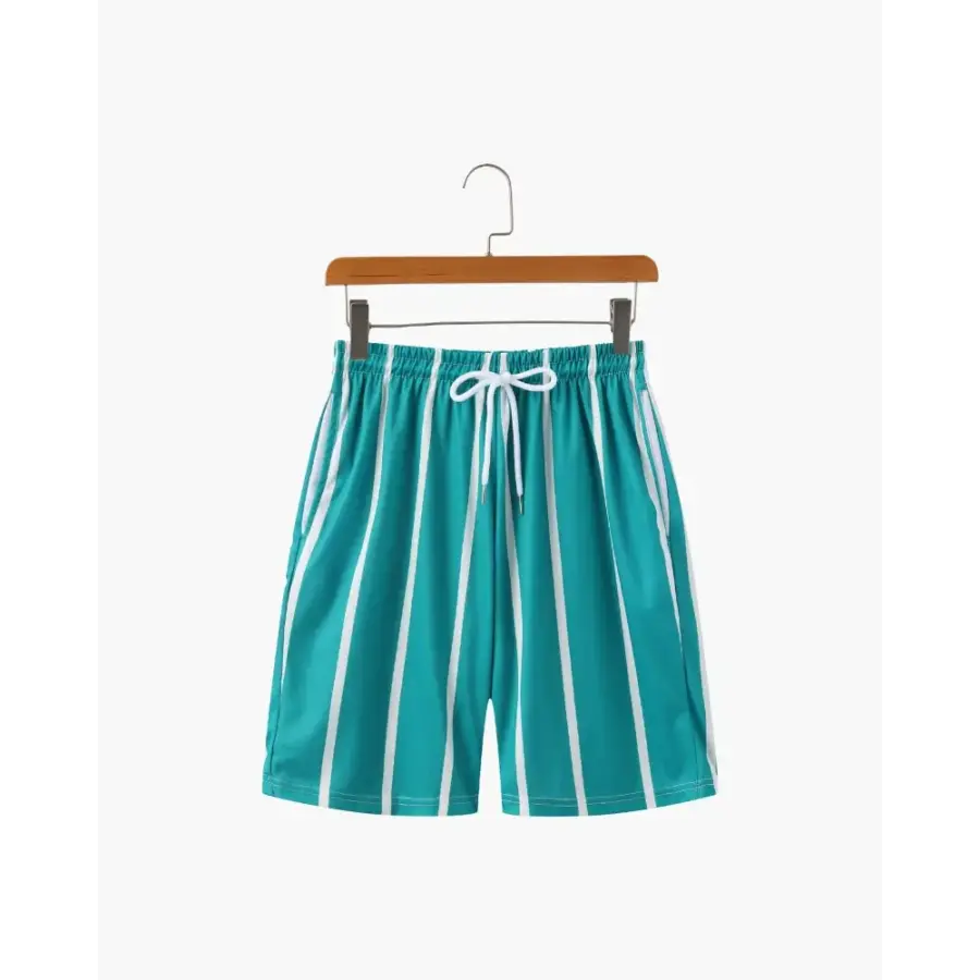 Riviera swim briefs in forest green stripe, poolside style worn with white towel and sunglasses