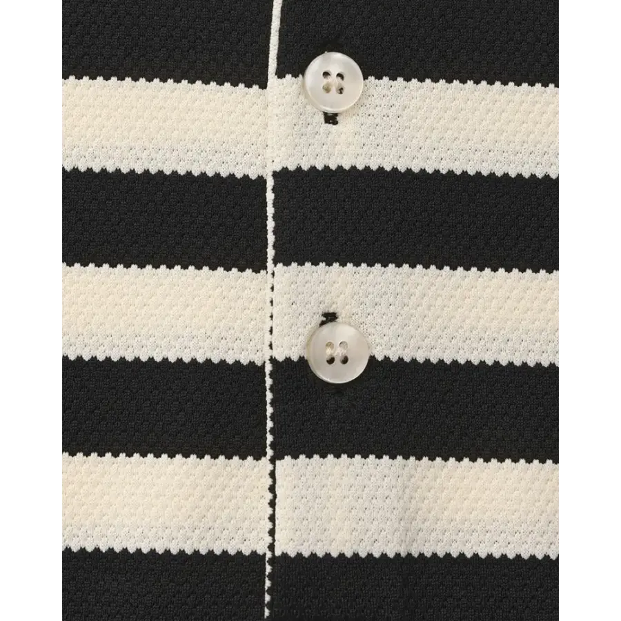 Close-up of hand-finished ivory contrast collar on textured polo