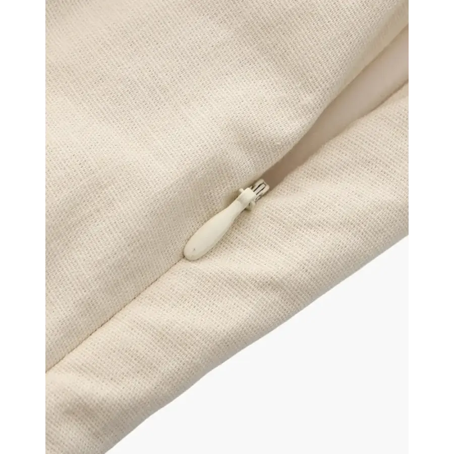 Beige mini dress detail shot of darted seams and structured cotton fabric