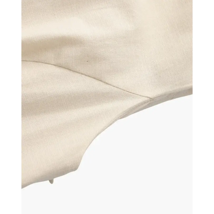 Sculpted beige mini dress styled with blazer and ballet flats for office wear