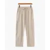 Signature beige linen pants, straight leg, folded to show natural fabric texture and weave