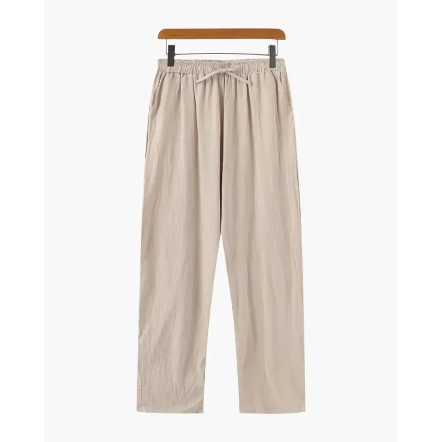 Signature beige linen pants, straight leg, folded to show natural fabric texture and weave