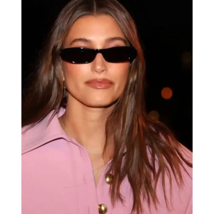 Vintage oval sunglasses worn on model, black colorway, outdoor light