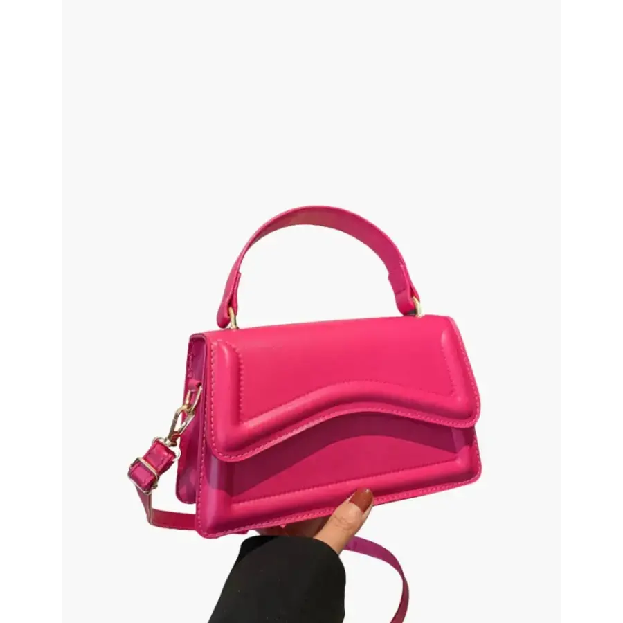 Petite top-handle bag in muted pink rose canvas, held in hand