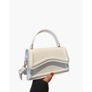 Petite top-handle bag in white canvas with leather handle, front view